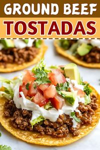 Crispy, flavorful ground beef tostadas topped with fresh veggies, refried beans, and cheese are easy to make, fun to eat, and perfect for weeknight dinners!