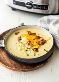 Slow Cooker Corn Chowder captures the taste of summer whether you use fresh or frozen corn kernels. Top this rich, creamy chowder with bacon, green onions, and cheddar cheese. This is an easy soup recipe that will become a favorite summer recipe! | InquiringChef.com