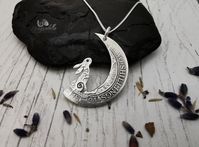 "Hare in the Moon pendant Individually hand drawn and loving cut in to a solid silver two shilling coin from pre 1920 Approx 2.8cm in diameter. Each pendant is slightly different due to the age of the coins used, the differing designs on the coins (depending on age) and the handcarved nature of how they are made Comes beautifully gift boxed with a 18\" sterling silver chain Other designs are available, please ask. Custom orders welcome Some examples are on my FB page. Please take a look www.face