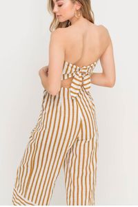 Slip into the Molly Tan Striped Strapless Midi Jumpsuit! Lightweight linen blend fabric falls from the strapless bodice into a fitted waist and wide-cut culotte pants with hidden side seam pockets. Cute tie crosses over cutout back