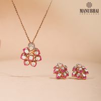 Polki studded within pink enamel, brought together to illuminate your festive looks. This elegant pendant set is a versatile addition to your collection.