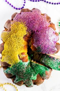 Vegan King Cake / non-dairy milk, non-dairy butter, yeast, cane sugar, egg replacer, ap flour, coconut sugar or brown sugar, pecans, raisins, powdered sugar, sprinkles