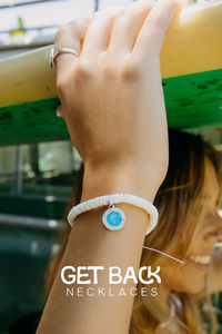 This cool and breezy bracelet features stunning white puka shell beads, bringing that laid-back, sun-kissed beach feel to any outfit. The crisp white shells evoke memories of sandy shores and lazy days under the sun, making it a must-have for any beach lover.

- Wax coated nylon string, adjustable closure 

- Bracelet length adjustable from 2"-5" 

- 4mm white rondelle puka shell beads  

- Features a small Aqua / White St. Christopher 