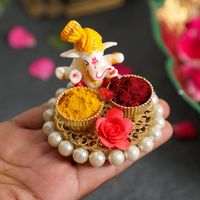 A Haldi and Kumkum holder is an essential part of every Indian Hindu household. No tradition or ritual is called complete without Haldi and Kumkum.This holder is adorned with a sitting figurine of Lord Ganesh. And adds the right amount of cultural beauty to your pooja room.Pamper your pooja spaces and traditional ritual days with this carefully crafted holder from DesiFavors.Long-lasting beauty, perfect for gifting, a must-buy product for poojas, weddings, and other festive and personal celebrat