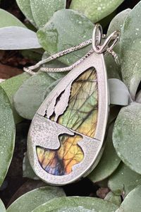 The ever changing colors of Labradorite have long been compared to the aurora borealis, or Northern Lights, which can be seen on particularly cold nights here in the North. Wear this pendant to bring a little bit of that magic with you wherever you go. Handmade by Beth Millner Jewelry.