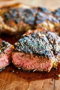 cooked steak cut on a wood cutting board