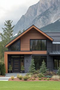 Modern mountain house facade with dark grey sliding accent walnut wood slatted wall dark grey window trim and door metal roof mulched frontyard. Check out the trending exterior colors for modern mountain houses that blend harmoniously with natural surroundings while adding a touch of contemporary flair.