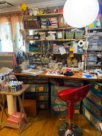 My red chair is so fun and functional. Under counter storage of assorted fabrics. In the moment the T.V. tray is for paint for a project.