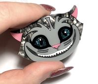 $29.95 - The Cheshire Cat in swirling grey acrylic combined with super glittery turquoise, complete with laquered eyes for a 3D effect. He measures approx 5x3.5cms.Designed and handmade in Melbourne, Australia