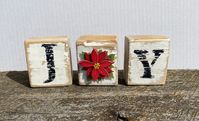 These rustic blocks are the perfect addition to your holiday decor! What a simple and unique gift for a teacher, co-worker, friend or family BONUS: They are already packaged to make them even easier to gift!! Each block set is packaged in a plastic, poly bag with holiday colored raffia added, and tied with coordinating ribbon. Each set is cut from untreated white wood, stained, painted, sanded, sealed and a 3D sticker added for the O, to give them a rustic/distressed look.  Dimensions: Each block is approximately 2.5" H x 2" L x 1.5" W Materials: untreated white wood, oil based wood stain, acrylic paint, 3D paper sticker, Mod Podge, raffia, jute/ribbon, plastic poly bag blocks may vary slightly due to the nature of wood, and the individual hand work done to each block. Ribbon color may var