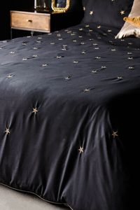 Reflecting the dense infinity of the night sky, this stunning bed linen collection comes in inky black with delicate gold star detailing – perfect for contrasting against muted Scandi decor or soft white walls. The elegant stars are beautifully picked out in gold embroidery, adding a magical effect to your bedroom space and echoing the gold piping that finishes the duvet cover edges perfectly. The 200-thread count lends a luxury finish to this bed linen set, plus thoughtful design means that one side of each pillowcase is star-free for optimal comfort. Don’t forget, your bed is the centrepiece of the room. Style it the RSG way and add cushions in a variety of sizes and contrasting colours to create a stunning statement piece with an undeniable wow factor. - Black Falling Star Duvet Cover a