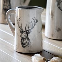 The Stag  Medium Distressed Pitcher Vase will add a charming design to your kitchen or dining table. The vase is crafted with ceramic in a distressed rustic design. Featuring a cream tone with a black stag's head on bringing a country charm to your home.  Height: 22 cm. Width: 18 cm. Depth: 15 cm. Weight: 1.02 kg.