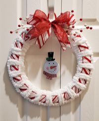 Adorn you wall or your inside door with this cute yarn snowman wreath. Made with white yarn and red strip ribbon. Decorated with a cute whimsical snowman. Adorn with a beautiful red and white stripe bow and red and white berries. Made on a 14 inch wire round frame. Very lightweight. Handmade by me with care. Ready for shipping.  Thank you for stopping by. "Favorite My Shop" to view all my new listings. Feel free to browse the rest of my shop: http://www.etsy.com/shop/BettyAnncreations.   Any questions please feel free to reach out to me @momdearest1953@yahoo.com