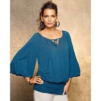 This is an example of a blouson top. It is fitted at the bottom (usually at or below the waist), causing the middle/top to blouse out.