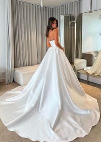 The Ayasha Wedding Dress is the epitome of elegance and romance. Made from luxurious satin fabric, this strapless ball gown creates a timeless and grand entrance. The sleeveless design adds a touch of sophistication, while the sweep-train adds a touch of drama. Perfect for the bride who wants a classic and sophisticate