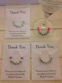 Favour and placecard all in one! Large wine glass charm with guest name. Available in any bead colour. Comes in a plastic pocket with a special message to your guests so they know what to do with their charm. Price: £1.25 each plus p&p