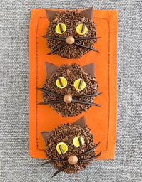 Black Cat Cupcakes: These cute kitties will especially appeal to chocolate lovers. Chocolate sprinkles, yellow gumdrops, black licorice laces and chocolate coating dots top a homemade chocolate cream cheese frosting.