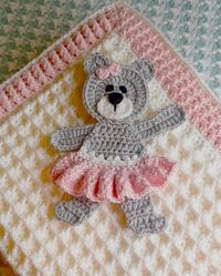 A soft Babykins wool and pink edging with a skirt little bear and a bow in her hair.  The wool is ideal for baby blankets.