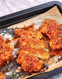 Incredibly juicy chicken thighs are coated with a crunchy cornflake breading, baked until perfectly golden, then smothered with a sweet and spicy hot honey sauce!