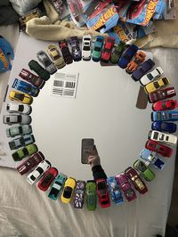 This is a round mirror bordered with die cast hot wheels! This item is not a toy for children to play with but a decor item and to be hung on a wall  ITEM IS MADE TO ORDER