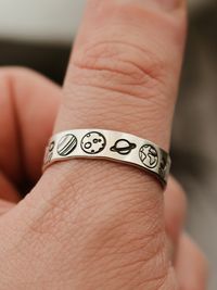 "Copy and paste into your browser, get 15% off ➔ https://bit.ly/VD15OFF For the space lovers in your life, this ring features celestial hands with the sun and the moon, centered by planets from the solar system. DETAILS: -Each ring is hand stamped -Ring is Sterling Silver, Fine Silver, or Gold Filled -6mm in thickness You will receive one hand-stamped ring filled with a black enamel finish. **Every item is handmade, this means that each will be unique and may not look EXACTLY like the picture, b