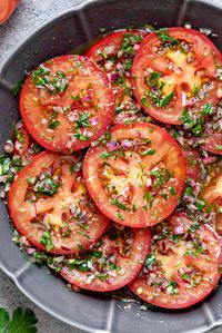 The recipe for homemade Marinated Tomatoes couldn't be any easier and as flavorful as this one! Fresh juicy tomatoes soaking in zesty vinegar, olive oil, and fresh herbs makes a perfect healthy summer salad, a topping or a side dish.