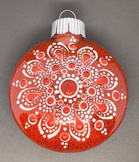 "This 3\" red plastic disk ornament is glittered on the inside with a beautiful red glitter. A mandala is painted with white acrylic paint on the front and top dotted with a color to match the glitter. It is then sealed with varnish. It makes a great gift for family, friends, coworkers, or for yourself."