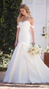 A unique style that mixes modern detailing with a traditional silhouette, turn heads in this silk wedding dress with ruching from Martina Liana. A completely-structured style, the neckline of this silk Zibeline gown is ruched and highlighted on either side with drapey, off-the-shoulder straps. From the waist, the fit-and-flare silhouette extends to the ground, featuring asymmetrical ruching that extends around to the back of the gown.