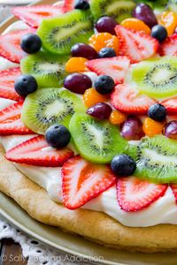 Classic colorful fruit pizza on a soft sugar cookie crust and topped with creamy, thick cream cheese frosting. Recipe by sallysbakingaddiction.com