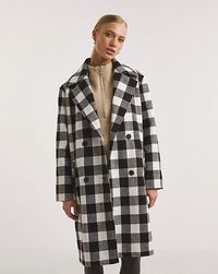 New in, our double-breasted Mono Check Wool Coat! This coat is chic and stylish featuring a wide collar and fully lined front pockets. Wear day to night, switching out your favourite jeans and boots with a little black dress and heels. Perfect for all occasions!