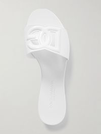 Find DOLCE & GABBANA Cut-out Rubber Slides on Editorialist. Dolce & Gabbana's slides have been made in Italy from glossy rubber that's embossed with a cutout version of the 'DG' logo. They're designed with wide straps and rest on the slightest heels. The bright white shade will go with nearly anything.