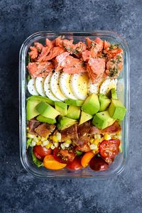 This Salmon Cobb Salad Recipe will be your new favorite way to enjoy a healthy lunch! Made with grilled salmon, avocados, hard-boiled eggs and more, this Grilled Salmon Salad is the perfect meal prep salad idea! #salmoncobb #salad