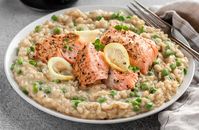 A creamy salmon risotto recipe with lemon, mascarpone, parmesan, peas, and pan-seared salmon. A perfectly cozy dinner for two!