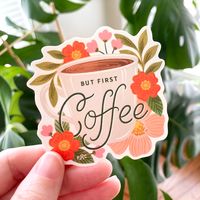 This cheerful sticker features a cup brimming with morning coffee, and blooming with sunny florals. A perfect mantra for any creative.These stickers are 3x3" size. Matte, durable vinyl protects your stickers from the elements. Peel off the backer and decorate your waterbottle, laptop, journal, or wherever you want to stick it! You'll want to collect them all :) 1 Diecut Sticker Durable, Matte Vinyl Coating Measures Approx. 3" Tall x 3" Wide Full, gorgeous color