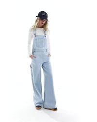 Jumpsuits & Playsuits by Stradivarius Go all-in-one Classic dungarees design Adjustable buckle straps Buttoned sides Functional pockets Wide leg Regular fit