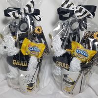 "2022 Graduation gift basket- Celebrate the Grad with this cute gift basket. This gift basket consist of the following items: - a grad coffee mug (with candy inside) - GRAD novelty sunglasses - a unicorn with \"GRAD\" on it - snacks - Oreo (2-pack) The gift will come wrapped in cellophane paper tied with a bow. There may be different variations of items in the basket but your gift will be just as nice."