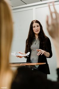 Woman explaining aerodynamics in a classroom | premium image by rawpixel.com / McKinsey