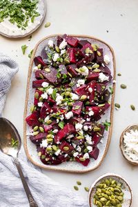 Beet and Feta Salad is a hearty and colorful fall salad that has layers of roasted beets, creamy feta cheese, and crunchy pumpkin seeds.