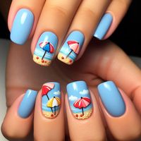 Nails with a soft blue base color, each nail featuring a small, hand-painted beach umbrella in bright colors like red, yellow, and blue. The umbrellas are depicted open, providing shade on a sunny beach day. The nails are short and rounded with a shiny top coat.