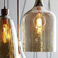 This stunning 1-bulb pendant light is one of a kind with a smoke luster glass shade. A taupe cloth cord adds to its' vintage appeal. 60 watt bulb (not included)