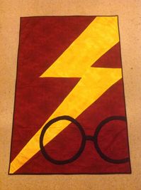 Harry Potter Griffindoor quilt. I made a pattern by copying a picture and top stitched the Lightning bolt and the glasses to the quilt.