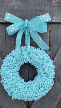 White or teal yarn wreaths for the baby nursery or the baby shower. Can also be used for any home decor you need a splash of teal or white. #pinklimewreaths #yarnwreaths #frontdoorwreaths #babywreaths #nurserydecor #newbabygifts #showergifts #nurserywreath #babydecor