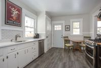 This kitchen features an exit to the backyard, along with an breakfast area. Click the link for more details on 163 Claremont Ave, located in Montclair, New Jersey. #montclair #montclairrealestate #njrealestate #Njrealtor #njhomes #craftsman nycsuburb #commuter #glenridge #Bloomfield #modernkitchen #whitecabinet #subwaytile #darkgrout #stainlesssteel #modernappliances #eatinkitchen #naturallight