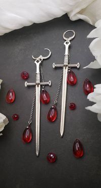 More coming soon! restocking in progress!  These gothic sword earrings add a dark flare to any outfit.  Originally designed and hand made for this shop!  These earrings are on the larger side. Lenght: 4.5in