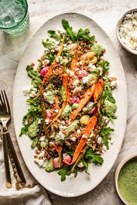 This Roasted Spring Vegetable and Crispy Farro Salad is the ultimate way to enjoy the season's best produce. It's loaded with a colorful mix of roasted veggies like carrots, asparagus, snap peas, radishes, and more, which get an amazing caramelized flavor! Then it's tossed with nutty crispy farro, peppery arugula, tangy feta, and a herby green goddess dressing. The result is a fresh, satisfying salad with an irresistible variety of flavors and textures that's easy enough for a weeknight dinner a