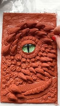 Hello! In this video, I'll show you how to make a 3D notebook cover out of hardening clay. And you will see that making such a cover is easy! Hope you like my idea! The details of the dragon were sculpted from clay, which hardens after a few hours. For work, I used the simplest tools that I found at home. I glued the parts on thick white glue. To add texture and more reliably glue the parts, I applied glue to the surface and covered it with semolina. When the cover was dry, I removed the excess semolina and painted with acrylic paints. Before applying bright colors, the black layer of paint must be completely dry.