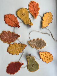 This gorgeous Autumn-inspired garland features eight wool-mix felt oak leaves and two felt pears.  They are strung on a jute twine which measures 1.20 metres in length and has loop holes at either end.  Each felt leaf measures approximately 12 cm in length and each pear measures approximately 13.5cm in length. The felt pieces can easily be removed from the twine and rearranged in whatever order you wish as they each have a sewn felt loop on the back. A beautiful garland for across a fireplace or doorway.