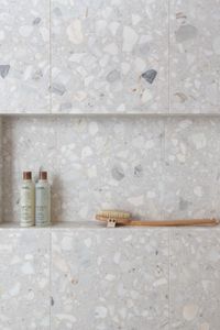 "As soon as Terrazzo Renata was released, it was on our must-have list! It has a soft, gorgeous, monochromatic texture that grounds my entire primary bath suite,” says designer Laura Umansky. Used for both the shower walls and flooring, the Ann Sacks Terrazzo Renata Field Tile in Brulee is the perfect backdrop for the brass shower fixtures. See the entire project on insidedesign.annsacks.com.

Design: Laura U Design Collective Photography: Michael Hunter