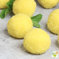 These Homemade Lemon Truffles are tangy, creamy and sweet. All you need is a few simple ingredients. After mixing the cake mix, sugar, butter, and lemon juice together, roll into small balls. Follow the recipe and the helpful video tutorial below! #LemonTruffles