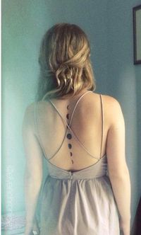 A down-the-spine temporary tattoo of the phases of the moon to show off a backless dress.   Photo:  Etsy